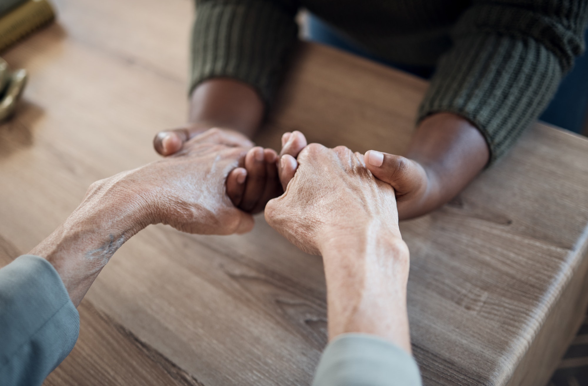 Holding hands, support and praying, people and counseling top view with psychology and therapy toge